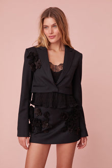 Black cropped blazer featuring handmade rosettes.