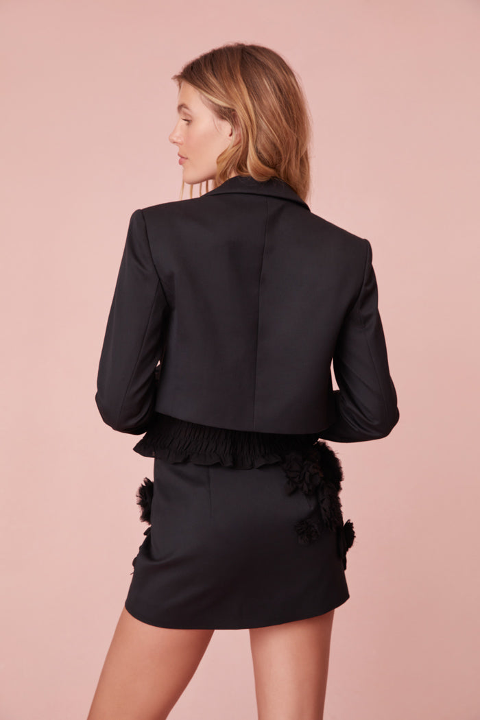 Black cropped blazer featuring handmade rosettes.