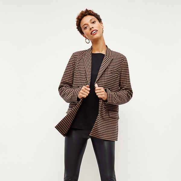 Front image of a woman standing wearing the Harrington Leather—Vegan Leather in Black | Exclude