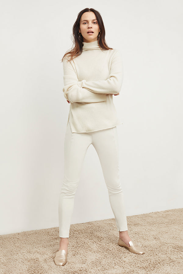 Front image of a woman standing wearing the Curie Pant—Everstretch in Bone | Exclude