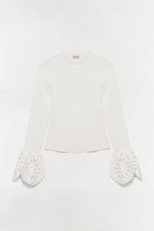 Cream ribbed knit top with long sleeves featuring openwork embroidered cuffs in a scalloped petal design.