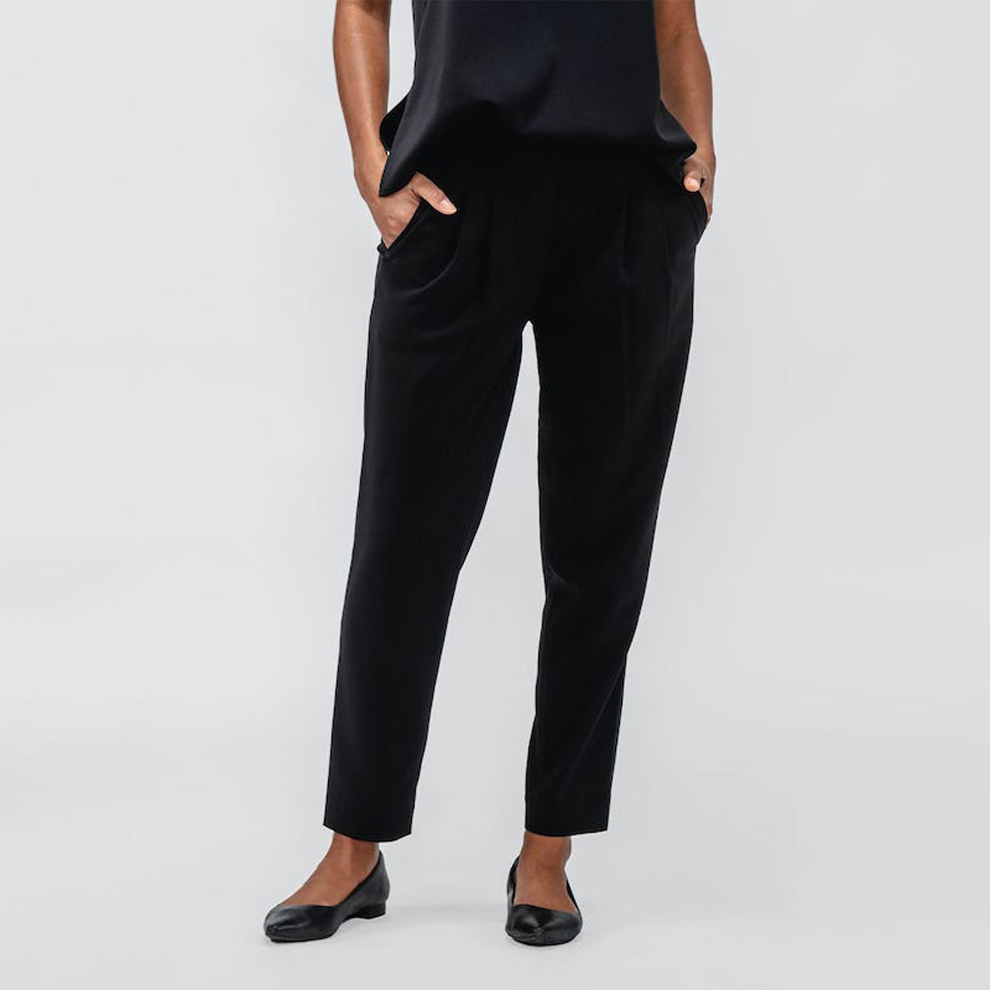 Women's Black Swift Drape Pant on model with hands in pockets