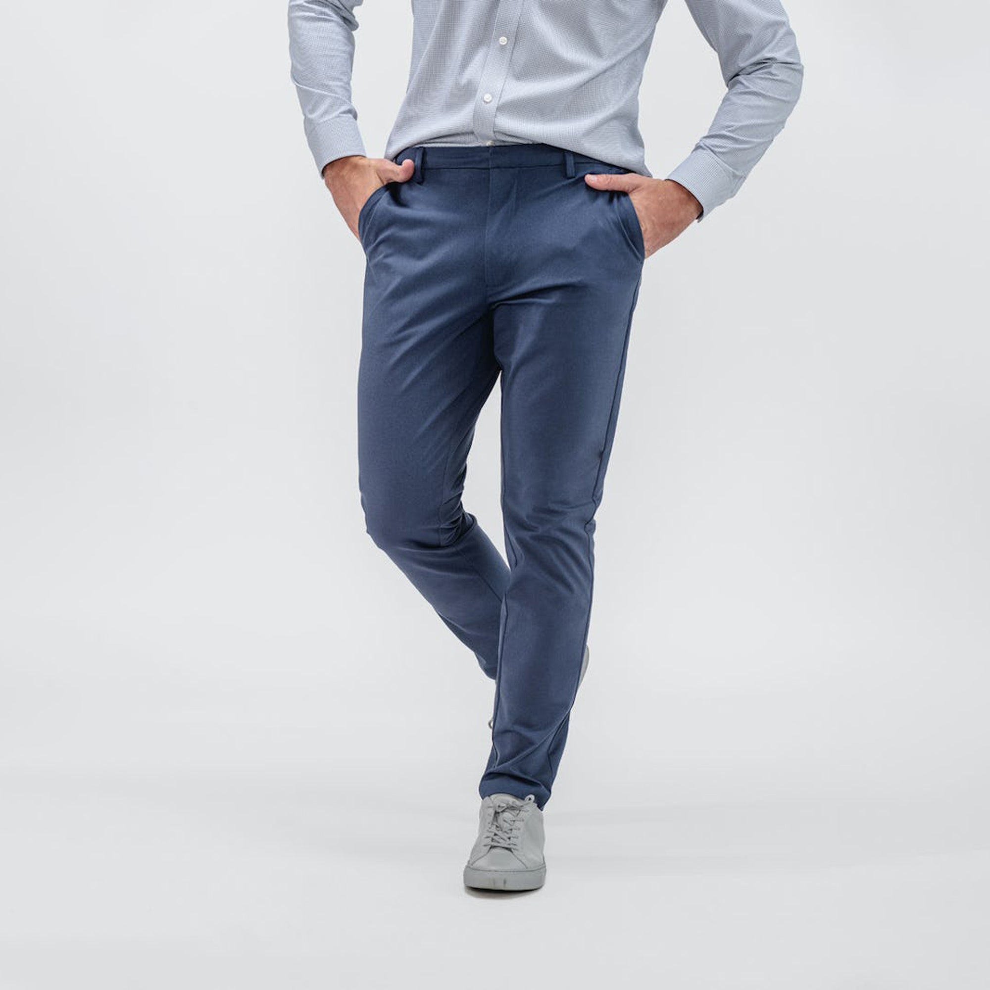 on model mens kinetic tapered pant slate blue waist down both hands in pocket