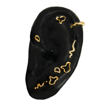 14K recycled gold Full Pavé Small Ripple Climber Earring on an ear with various earrings on a white background
