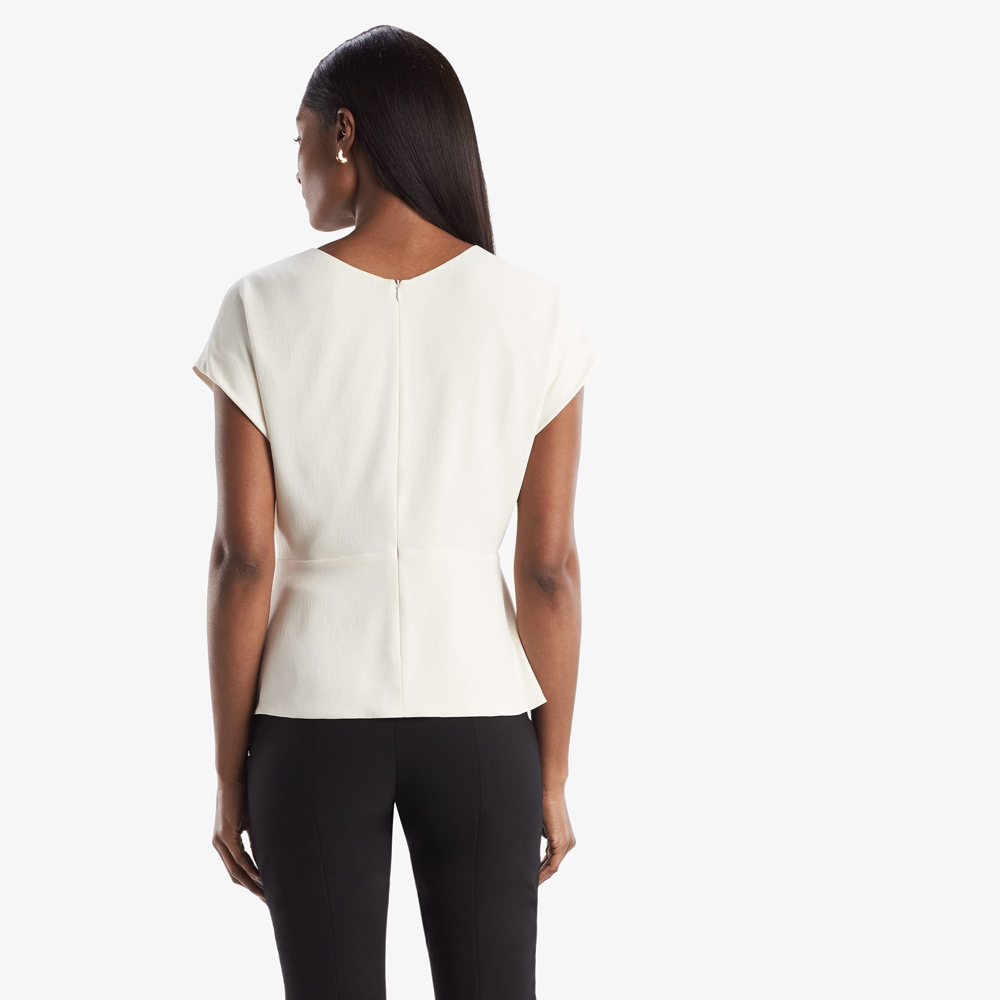 Back image of a woman standing wearing the Nejvi Top in alabaster | Exclude