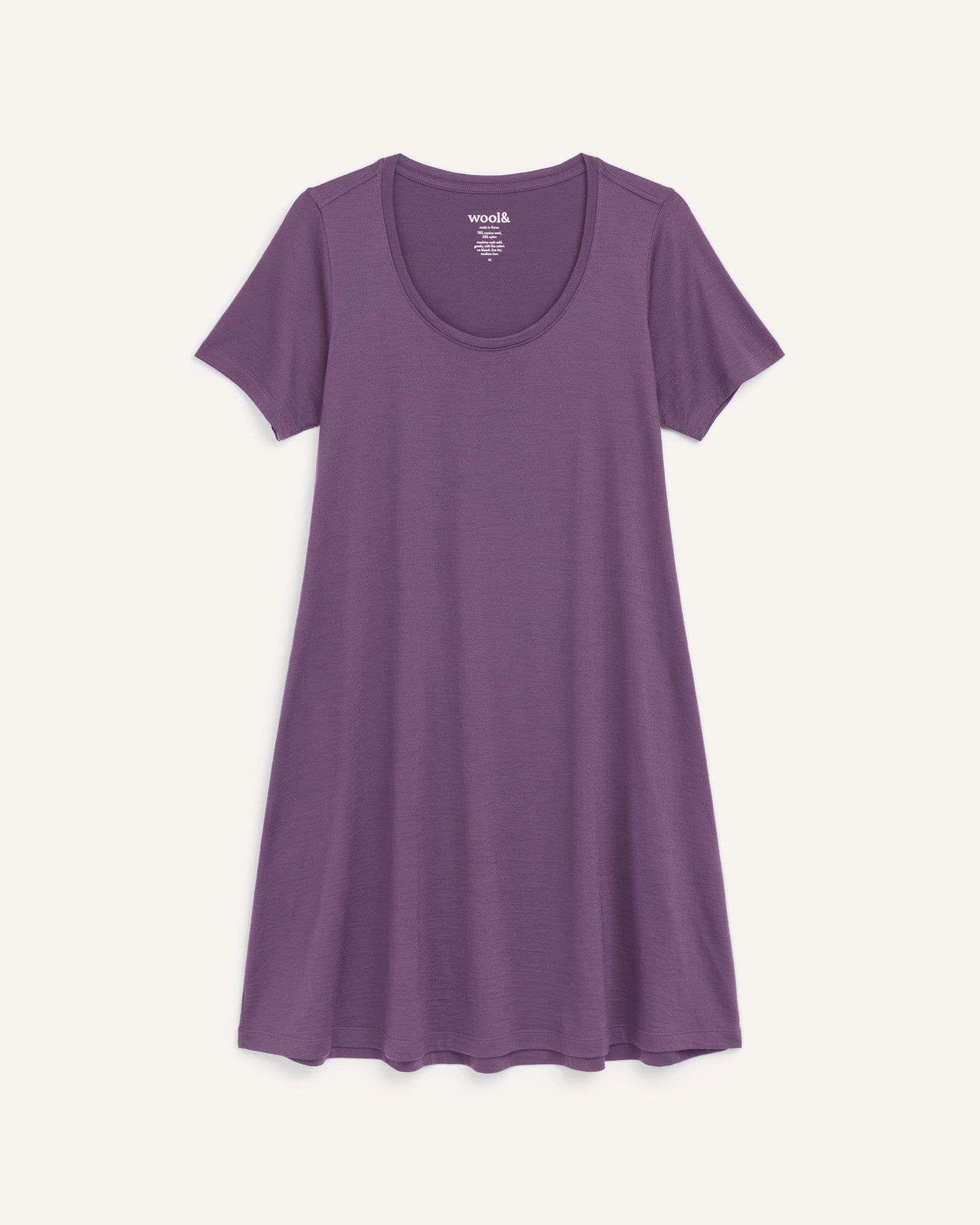 Laydown of Maggie Swing Dress in Purple Fig, a soft medium purple color. Maggie Swing Dress is a merino wool short sleeve, scoop neck, knee length swing dress with pockets available in sizes XS-3X Regular, XS-3X Long.