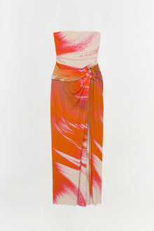 Strapless jersey gown with orange and pink watercolor print, ruched bodice, and side-tied waist detail.