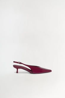 Burgundy patent leather slingback heel with pointed toe and thin kitten heel.