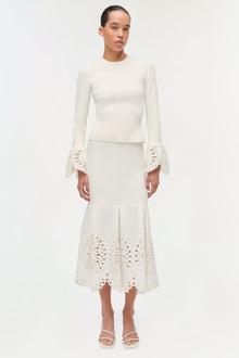 Cream knit top with long sleeves featuring lace embroidered cuffs and hem details.