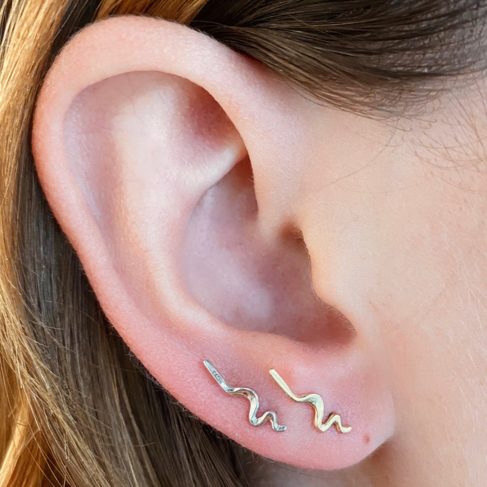 14K recycled yellow and white gold Small Ripple Climber Earrings styled together on an ear
