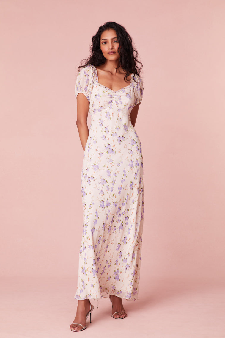 Floral printed maxi dress with short puff sleeves, a slightly square neckline with ruching at center front, and a breezy maxi skirt.