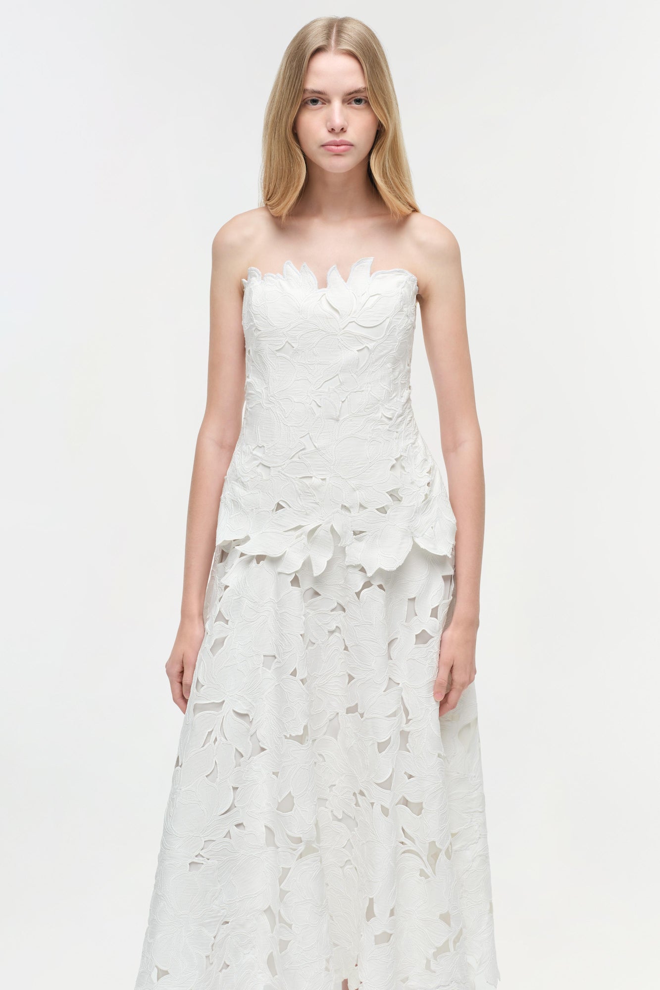 White strapless midi dress with all-over leaf embroidery pattern and sweetheart neckline.