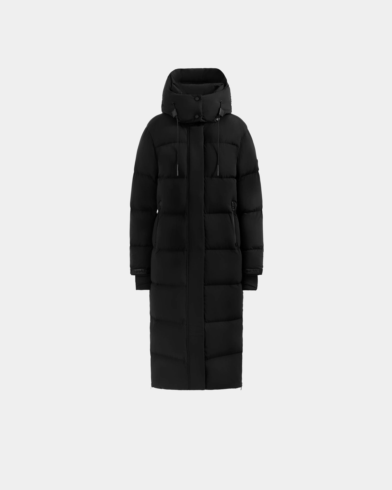 The Rudsak ALESSANDRA L - L125553 Black is a long black quilted down puffer coat with hood, front zipper and button closure, horizontal quilting, and side pockets—your winter essential shown on a plain light gray background.