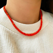Shimmering beaded necklace made of faceted opals in shades of deep fire orange on a gold linking lobster clasp.