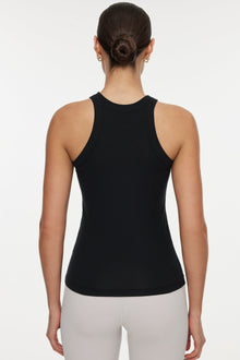 Model wears a high neck black tank. 