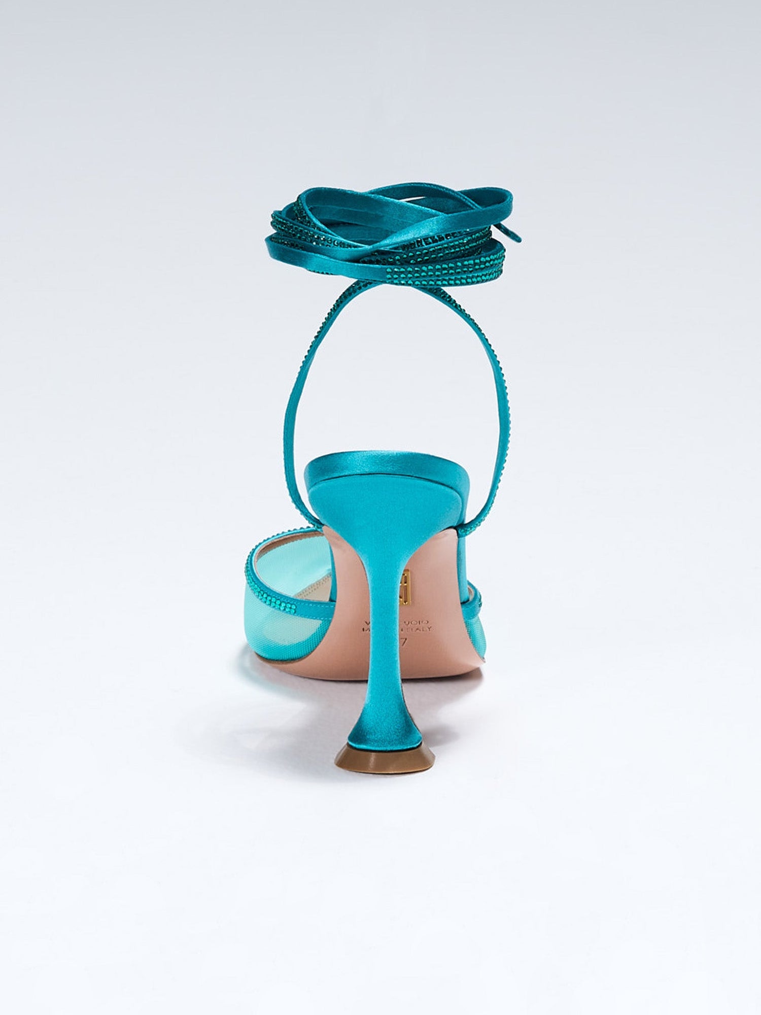 Dani Lace up on Model. TEAL SATIN LACE-UP WITH CRYSTAL EMBELLISHMENT Hand-crafted in Italy, the Dani ("Dani") lace-up features a glossy teal satin and is set upon our custom 95mm heel designed for your comfort. Dani is accented with our signature mesh upper that gently molds to your foot and is adorned with rows of glistening crystals that wrap around your foot and leg for an irresistible touch of sparkle.