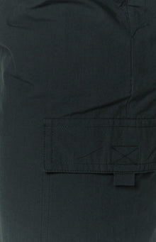 Close-up of the indigo cargo skirt fabric showing a flap pocket with visible stitching