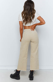 High waisted beige corduroy pants with wide legs and a raw frayed hem