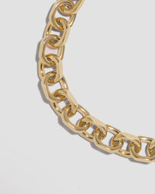 Close up of necklace chain on grey background. 