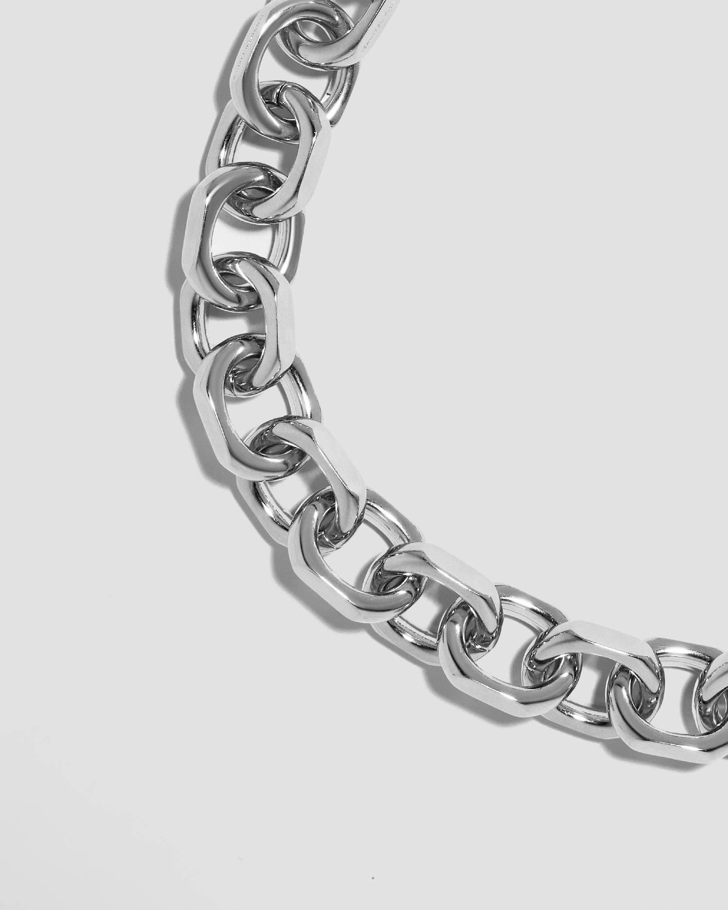 Close up of necklace chain on grey background. 