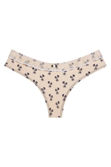 Cream bikini bottom with black floral print and ruffled edges at the waistband.