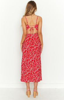 Rear view of a red floral midi dress with a tie-back bodice and waist cutouts