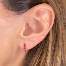 Half diamond  & Half ruby Pavé Hoop Earrings on an ear