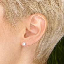 14k white gold White Pearl Stud Earring styled on a ear