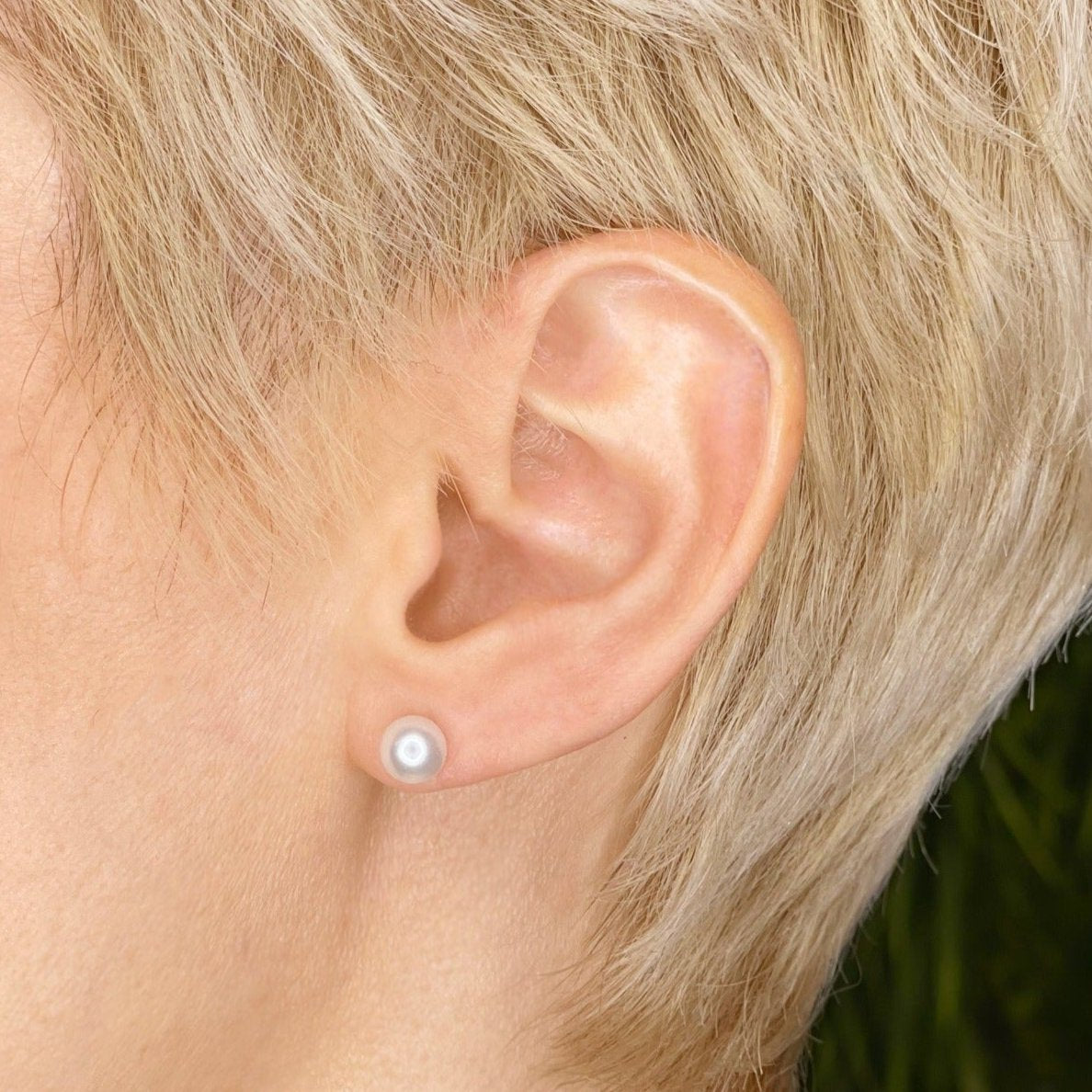 14k white gold White Pearl Stud Earring styled on a ear