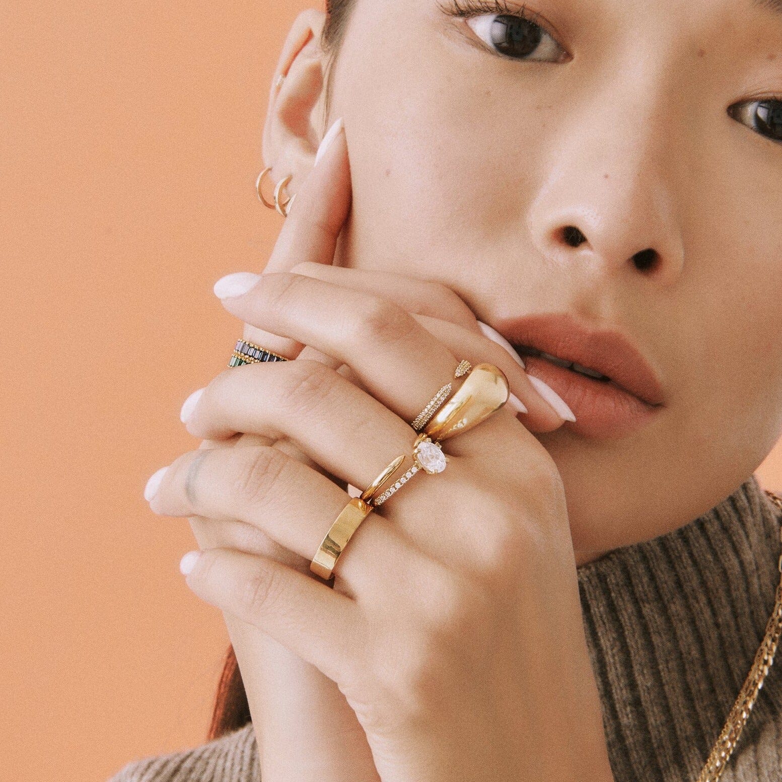 Lifestyle Model woman wearing various gold rings on both hands