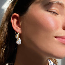 14k gold White Teardrop Coin Pearl Hoops styled on a ear