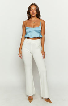 Blue satin crop top with a sweetheart neckline, thin spaghetti straps, and a ruffled peplum hem