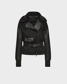 The Rudsak HALA - 8124521 Black womens jacket features black leather and shearling, an asymmetrical zipper, wide lapel, front pocket, and belted waist—shown on a plain light gray background for a chic fall look.