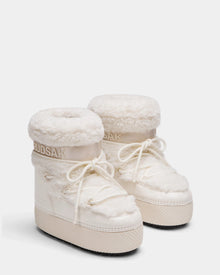 The Rudsak KATHY Y - 1224500 Iceland boots are white, fur-lined winter boots with thick soles, round toes, lace-up fronts, water-repellent finish, plush texture, and RUDSAK branding on the cuffs.