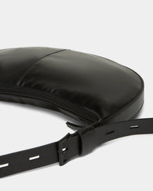 A close-up of the Rudsak LANISSA - 8324505 Black hobo bag, featuring a curved design, visible stitching, zipper closure, and an adjustable strap with rectangular holes—perfect as a chic womens crossbody accessory.