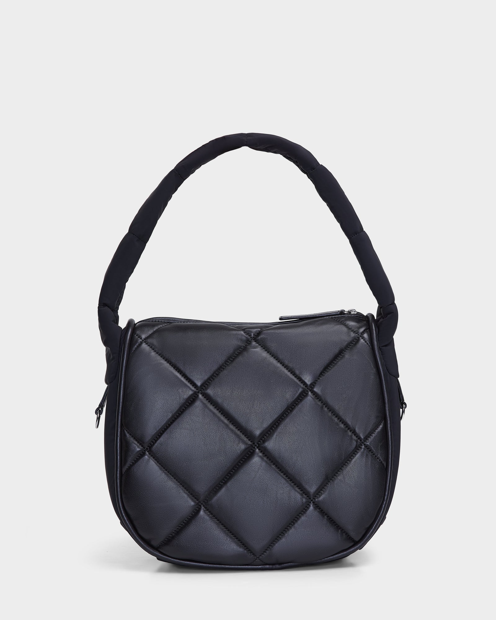 The Rudsak NIOBE L - 8324503 Black is a black quilted handbag featuring a padded curved handle and zippered top, displayed against a plain white background.