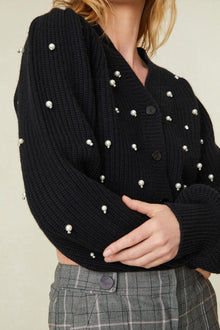 weater features pearl and crystal embellishments all over the front and the long blouson sleeves 