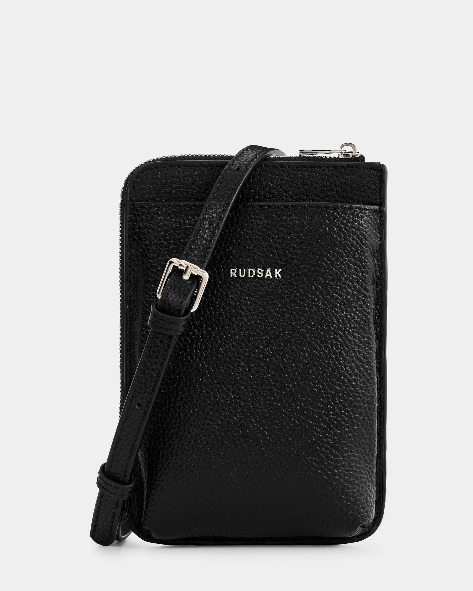 The Rudsak CELYN - L325514 Black is a stylish women’s pebbled leather crossbody bag with a front pocket, adjustable strap, silver buckle, and the Rudsak CELYN logo in silver on the front.