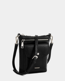 The Rudsak LILA - L325513 Black is a small women's crossbody bag in pebbled leather with silver hardware, a front flap pocket, top zipper closure, adjustable strap, and the RUDSAK logo in silver on the front.