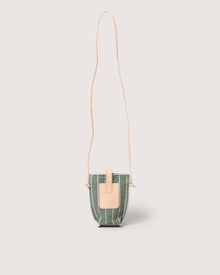 The Graf Lantz Hana Canvas Phone Crossbody is a compact green fabric bag with vertical beige stripes, a tan leather flap closure, and a long tan strap, shown against a light neutral background.