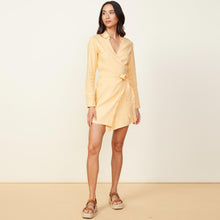 Front view of model wearing the linen mini dress in sand.