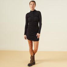 Front view of model wearing the flat rib mock shirred dress in black.