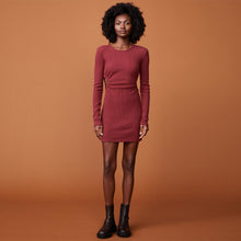 Front view of model wearing the brushed rib cut out dress in rhubarb.