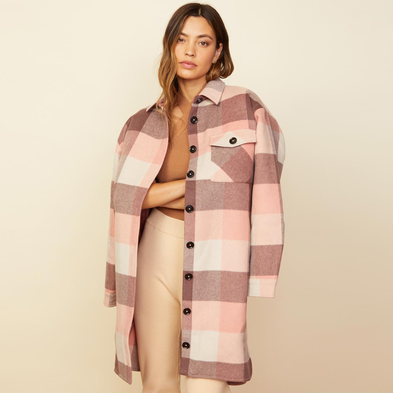 Front view of model wearing the long woolen shirt jacket in pink.