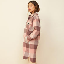 Side view of model wearing the long woolen shirt jacket in pink.