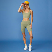 Full View of model wearing the Movement Sports Bra in Army