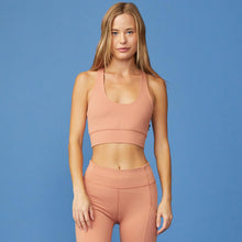 Front View of model wearing the Movement Sports Bra in Faded Rust