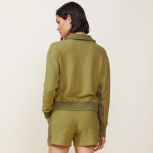 Back view of model wearing the fuzzy fleece polo sweatshirt in willow.