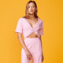 Front view of model wearing the linen front twist top in bubble gum.