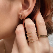 14k gold bead rings styled on a hand